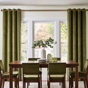 Moss Green Velvet Curtains in a Spacious White Dining Room with a Brown Wooden Table and Soft Green Chairs, Flower Vase