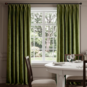 Luxurious floor-length Moss Green curtains framing a large window in an elegant dining room