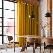 Mustard Yellow Linen Grommet Curtains in an Industrial Dining Room with Black-Framed Windows and Exposed Wood Beams
