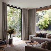Natural Linen Back Tab Extra Long Curtains in a Contemporary Living Room with Floor-to-Ceiling Windows and Garden Views