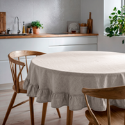Natural Linen Round Ruffle Tablecloth in a Minimal Kitchen with White Tile Walls and Warm Wood