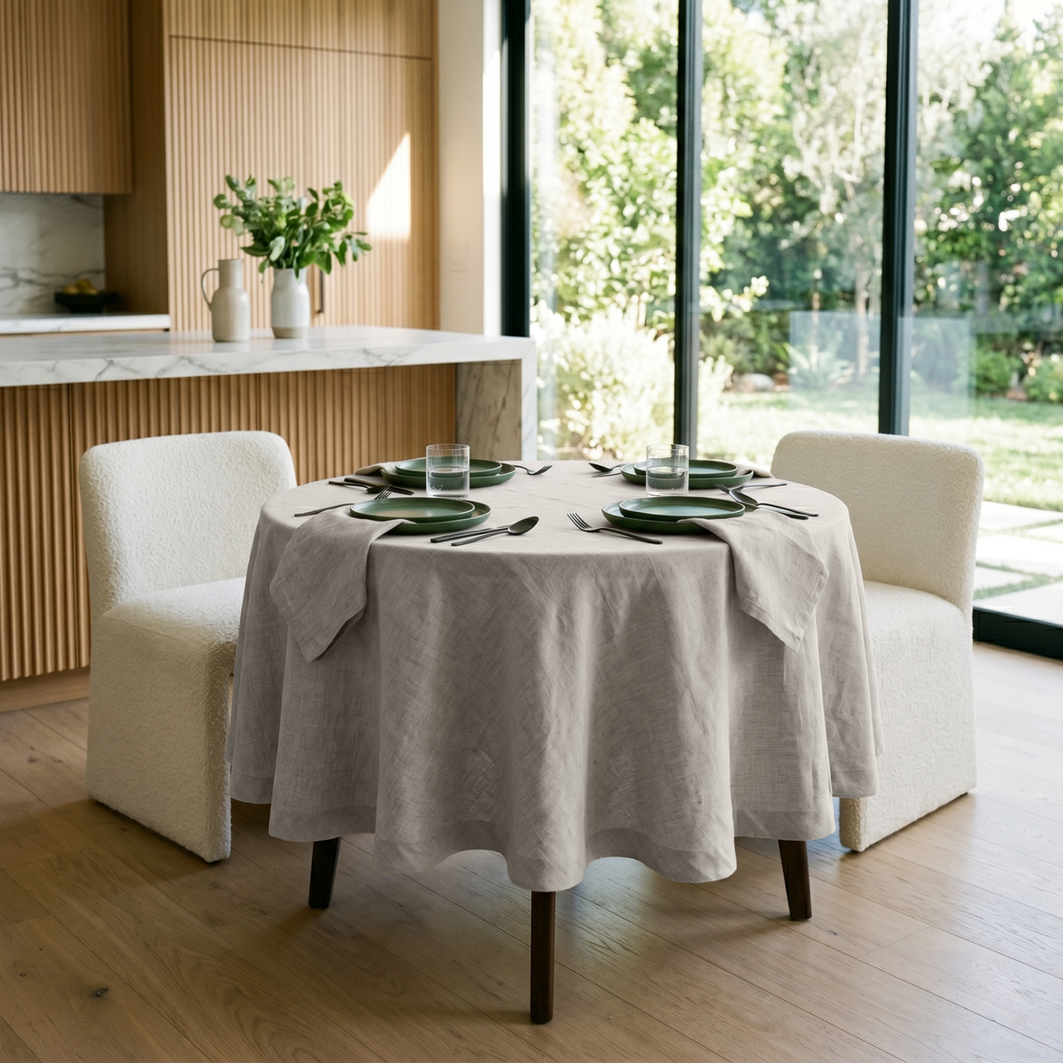 Natural Linen Small Round Tablecloth in a Bright Kitchen Dining Space with Light Wood Slat Cabinetry and Cream Bouclé Chairs