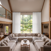 Off-White Heavy Weight Linen S-Fold Extra Long Curtains in a Contemporary Double-Height Living Room with Large Garden Windows and Neutral Seating