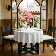 Off-White Heavy Weight Linen Small Round Tablecloth in a Mediterranean Dining Nook with Arched Windows and Black Wood