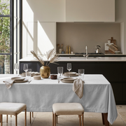 Off-White Rectangular Velvet Tablecloth in a Contemporary Kitchen with Black Cabinetry and Cream Upholstered Stools