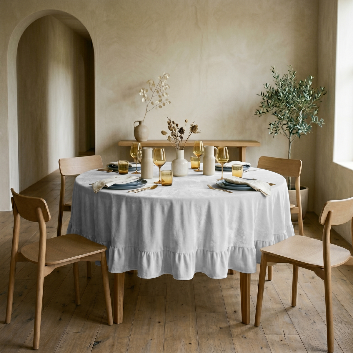 Off-White Velvet Round Ruffle Tablecloth in a Minimal Dining Room with Beige Plaster Walls and Light Wood