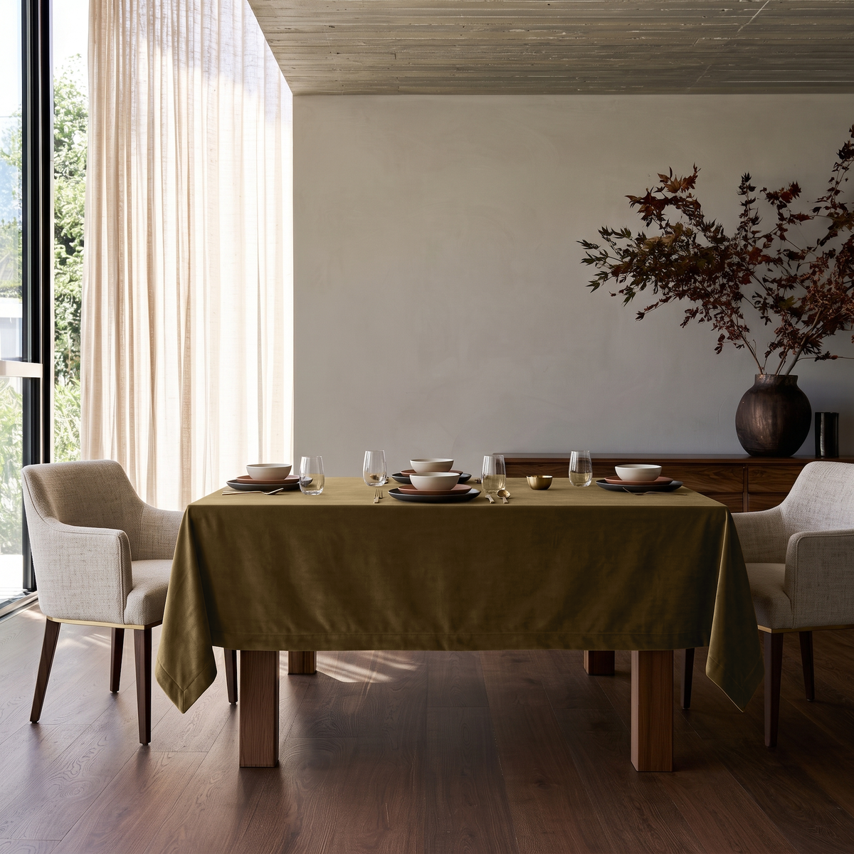 Olive Brown Rectangular Velvet Tablecloth in a Modern Organic Dining Room with Cream Upholstered Chairs and Walnut Sideboard