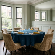 Peacock Blue Linen 72 Inch Round Tablecloth in a Classic Dining Room with Pale Green Paneled Walls and Camel Velvet Chairs