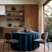 Peacock Blue Linen 90 Inch Round Tablecloth in a Warm Kitchen Dining Space with Walnut Cabinetry and Gray Velvet Chairs