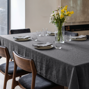 Dim Grey Rectangular Linen Tablecloth in a Contemporary Dining Room with Modern Fireplace and Floral Centerpiece