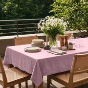 Dusty Rose Rectangular Linen Tablecloth in an Outdoor Contemporary Dining Area with Cane Chairs