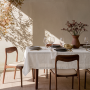 Off-White Rectangular Linen Tablecloth in a Modern Organic Dining Room with Walnut Chairs and Terracotta Vase