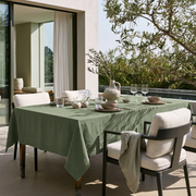 Asparagus Green Rectangular Linen Tablecloth on a Modern Outdoor Terrace with Cushioned Armchairs