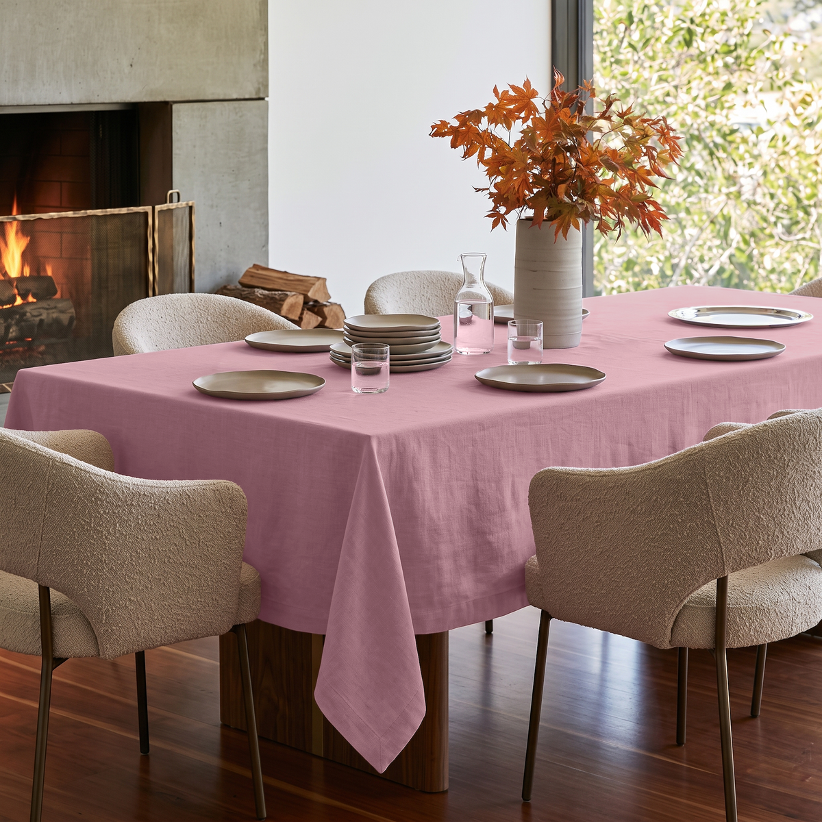 Dusty Rose Rectangular Linen Tablecloth in a Modern Organic Dining Room with Bouclé Chairs and Statement Fireplace