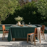 Hunter Green Rectangular Velvet Tablecloth in a Contemporary Patio Dining Area with Tan Woven Chairs
