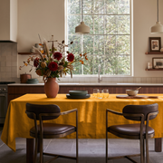 Mustard Yellow Rectangular Linen Tablecloth in a Modern Kitchen with a Large Window