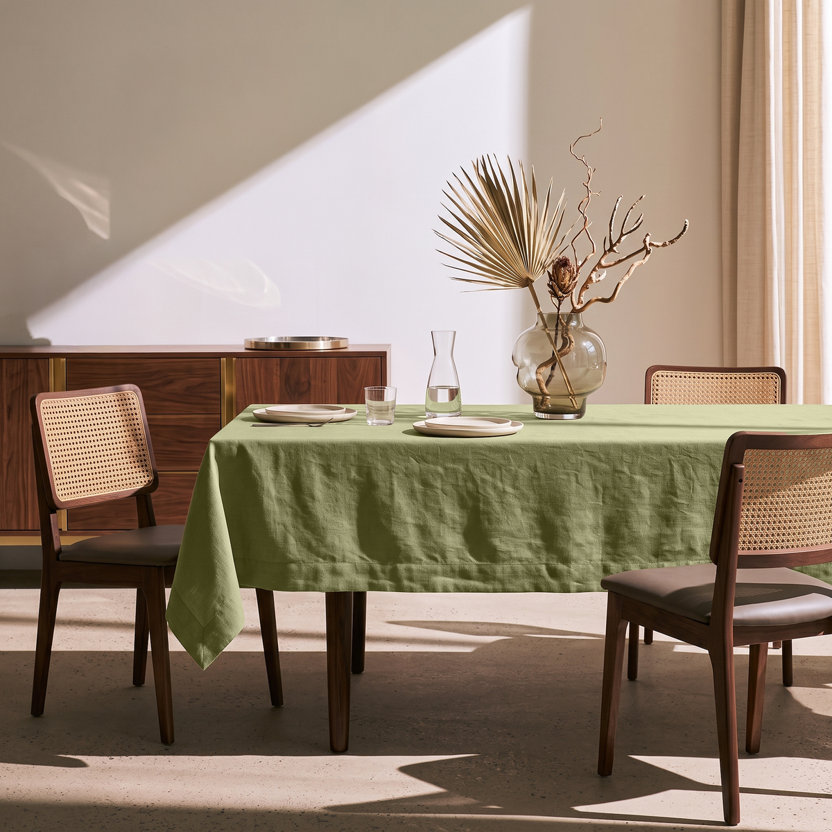 Olive Green Rectangular Linen Tablecloth in a Mid-Century Modern Dining Room with Cane Chairs and Walnut Cabinetry