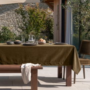 Olive Brown Rectangular Velvet Tablecloth in a Contemporary Patio Dining Area with Stone Walls
