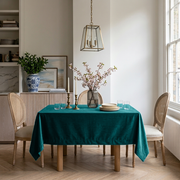 Teal Rectangular Velvet Tablecloth in a Transitional Dining Room with Cane Chairs
