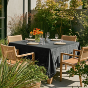 Dark Grey Rectangular Velvet Tablecloth in a Contemporary Patio Dining Area with Cane Chairs