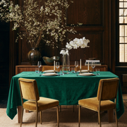 Emerald Green Rectangular Velvet Tablecloth in a Traditional Dining Room with Dark Wood Paneling and Mustard Velvet Chairs