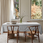Off-White Rectangular Velvet Tablecloth in a Scandinavian Dining Room with Wishbone Chairs and Cream Curtains