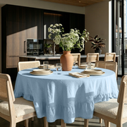 Sky Blue Linen Round Ruffle Tablecloth in a Modern Dining Room with Dark Wood Cabinetry