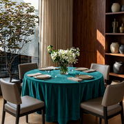 Teal Velvet Round Tablecloth in a Contemporary Dining Room with Warm Walnut Paneling and Taupe Chairs
