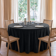 Steel Black Round Velvet Tablecloth in a Bright Dining Room with Sheer Drapes and Cane Chairs
