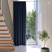 Royal Blue Linen Pencil Pleat Extra Long Curtains in a Minimalist Hallway with Wooden Staircase and Tall Window
