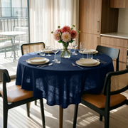 Royal Blue Linen Round Tablecloth in a Bright Kitchen Dining Space with Warm Wood Cabinetry and Tan Leather Chairs