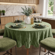 Sage Green Velvet Round Ruffle Tablecloth in a Classic Kitchen with Marble Backsplash and Light Wood