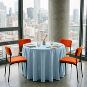 Sky Blue Linen 42 Inch Round Tablecloth in a City Dining Room with Concrete Walls and Orange Upholstery