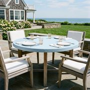 Sky Blue Linen Fitted Round Tablecloth in a Coastal Patio Dining Space with Ocean View and Weathered Wood