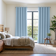 Sky Blue Linen Grommet Extra Long Curtains in a Bright, Modern Bedroom with Neutral Bedding and Natural Wood Accents