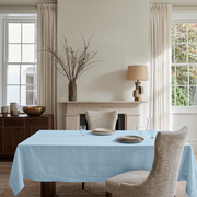Sky Blue Rectangular Linen Tablecloth in a Transitional Dining Room with Stone Fireplace