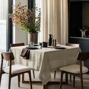 Ecru Square Heavy Weight Linen Tablecloth in a Modern Dining Room with Dark Cabinetry and Wooden Chairs