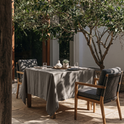 Natural Square Heavy Weight Linen Tablecloth in an Outdoor Dining Area with Woven Chairs