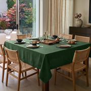 Forest Green Square Linen Tablecloth in a Contemporary Dining Room with Cane Chairs