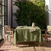 Olive Green Square Linen Tablecloth on a Mediterranean Patio with Cane Chairs
