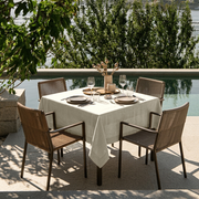 Ecru Square Heavy Weight Linen Tablecloth in an Outdoor Dining Area with Woven Chairs