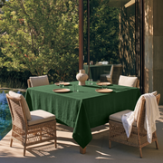 Forest Green Square Linen Tablecloth on a Contemporary Poolside Patio with Wicker Chairs