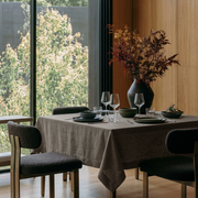 Natural Square Heavy Weight Linen Tablecloth in a Modern Dining Room with Black Bouclé Chairs