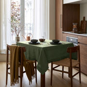 Sage Green Square Linen Tablecloth in a Modern Kitchen with Walnut Cabinetry and Natural Wood Chairs