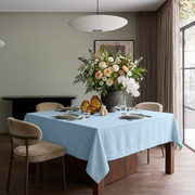 Sky Blue Square Linen Tablecloth in a Contemporary Dining Room with Beige Upholstered Chairs