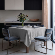 Stone Grey Square Linen Tablecloth in a Modern Kitchen with Black Cabinetry and Blue Velvet Chairs