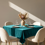 Teal Square Velvet Tablecloth in a Contemporary Dining Room with Bouclé Chairs