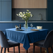 Steel Blue Square Velvet Tablecloth in a Modern Kitchen with Blue Cabinetry and Dark Velvet Chairs