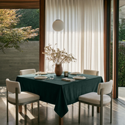 Hunter Green Square Velvet Tablecloth in a Modern Dining Room with Sheer Curtains and White Upholstered Chairs