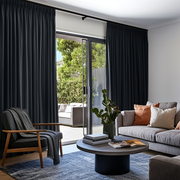 Steel Black Velvet Pencil Pleat Sliding Patio Door Curtains in a Contemporary Living Room with a Grey Sofa